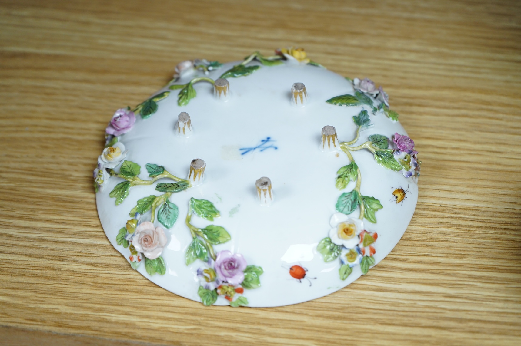 A 19th century Meissen floral encrusted cup and saucer, 14cm diameter